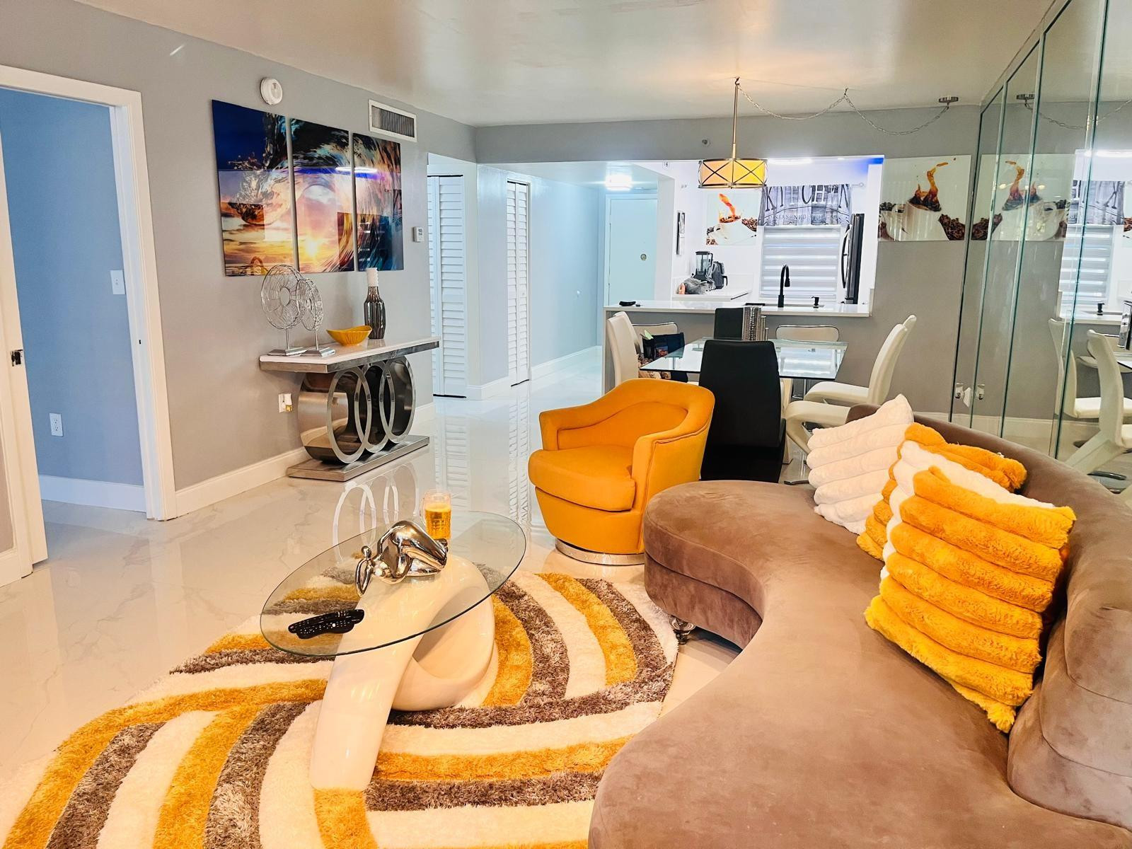 3910 Inverrary Boulevard, Unit 203B Lauderhill, FL 33319 - Photo 1 of 61 a living room with furniture and a flat screen tv