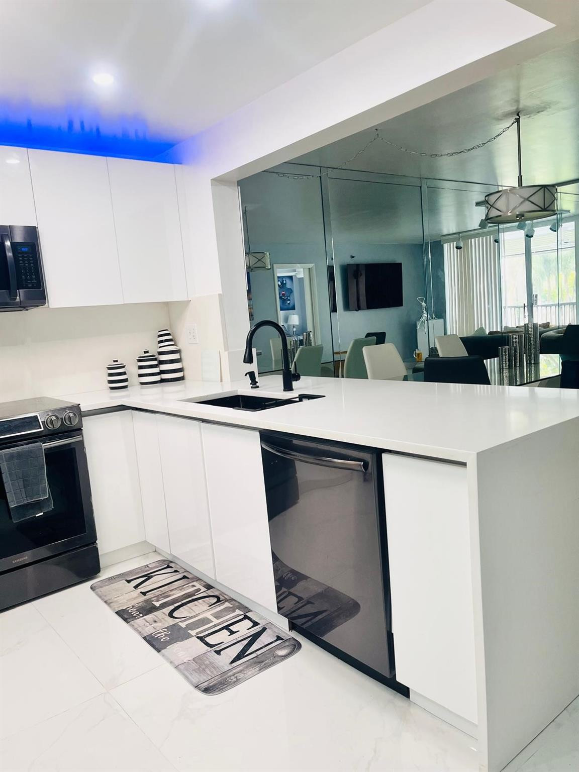 3910 Inverrary Boulevard, Unit 203B Lauderhill, FL 33319 - Photo 11 of 61 a kitchen with kitchen island a stove a sink and a refrigerator