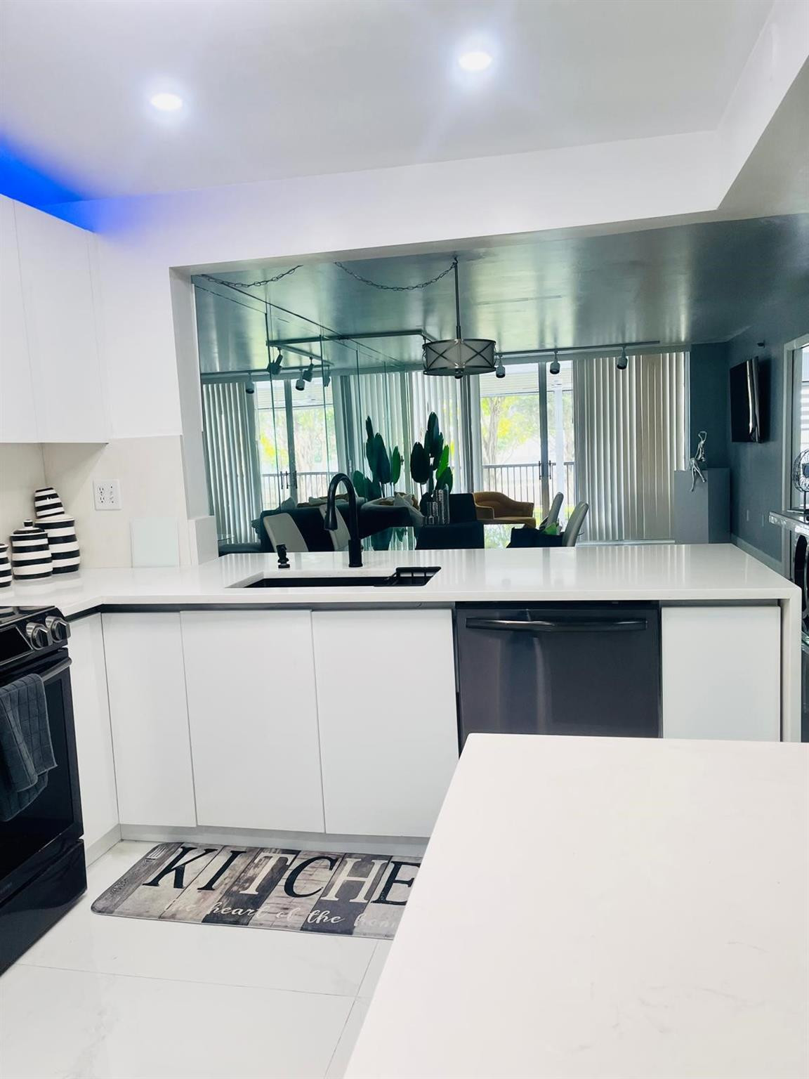 3910 Inverrary Boulevard, Unit 203B Lauderhill, FL 33319 - Photo 15 of 61 a kitchen with a sink a stove and cabinets