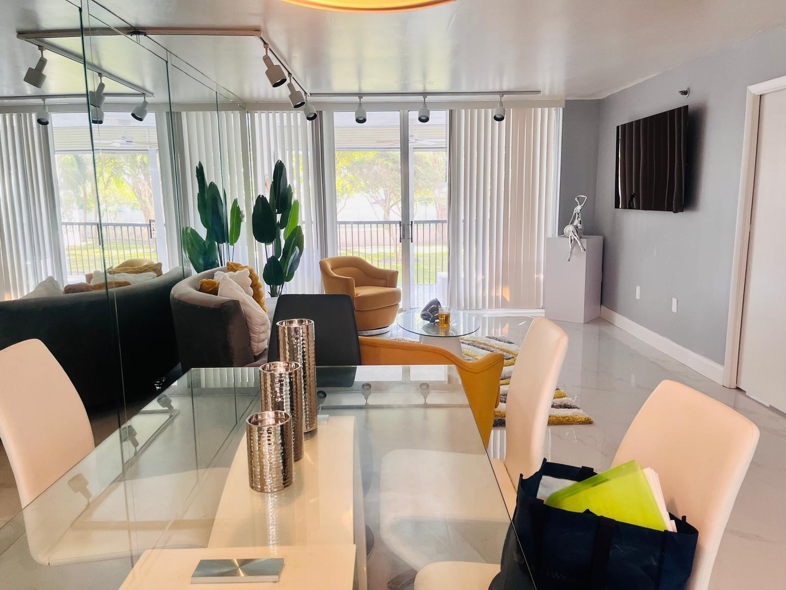 3910 Inverrary Boulevard, Unit 203B Lauderhill, FL 33319 - Photo 20 of 61 a living room with furniture and a flat screen tv