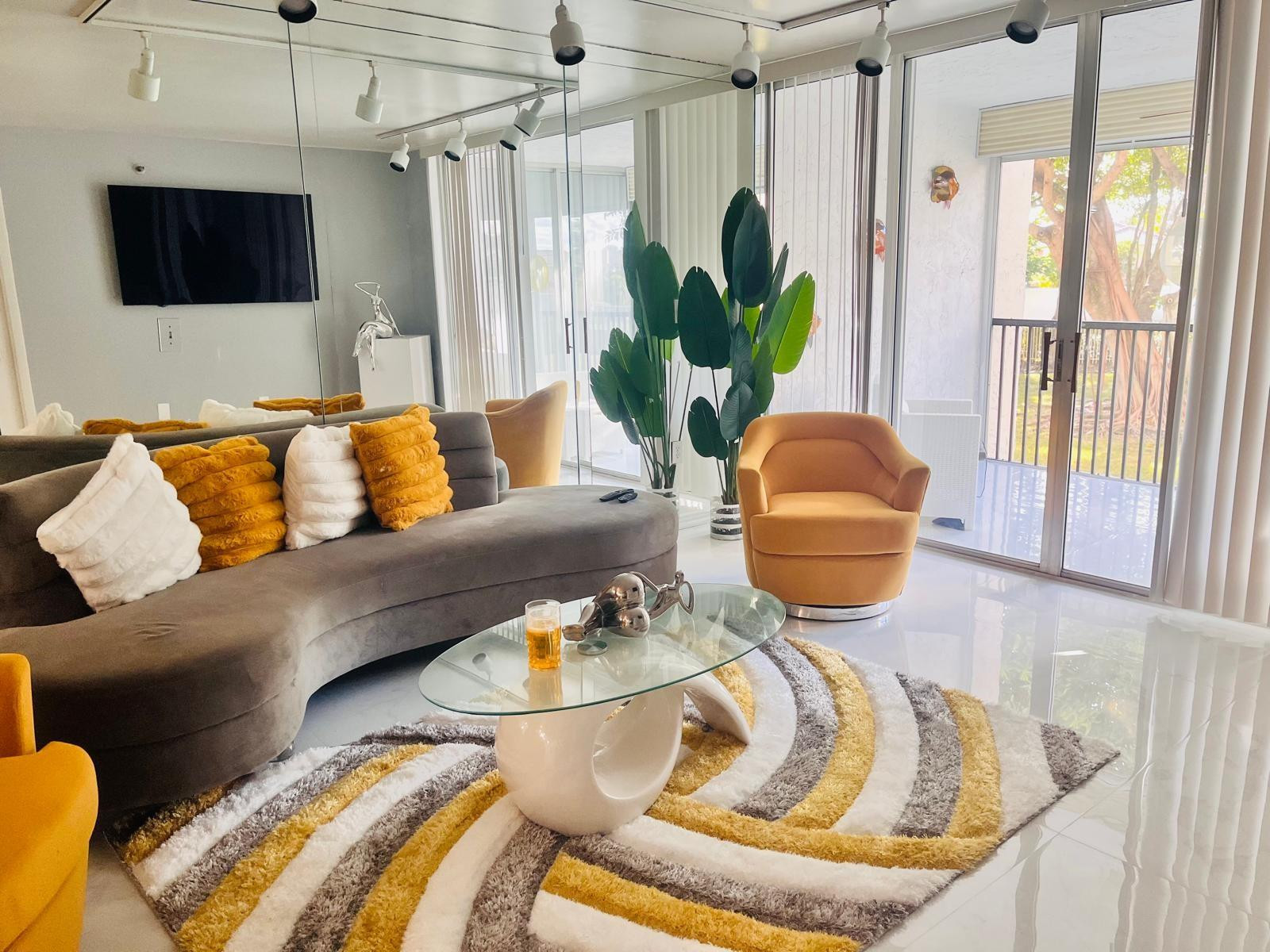 3910 Inverrary Boulevard, Unit 203B Lauderhill, FL 33319 - Photo 22 of 61 a living room with furniture and a flat screen tv