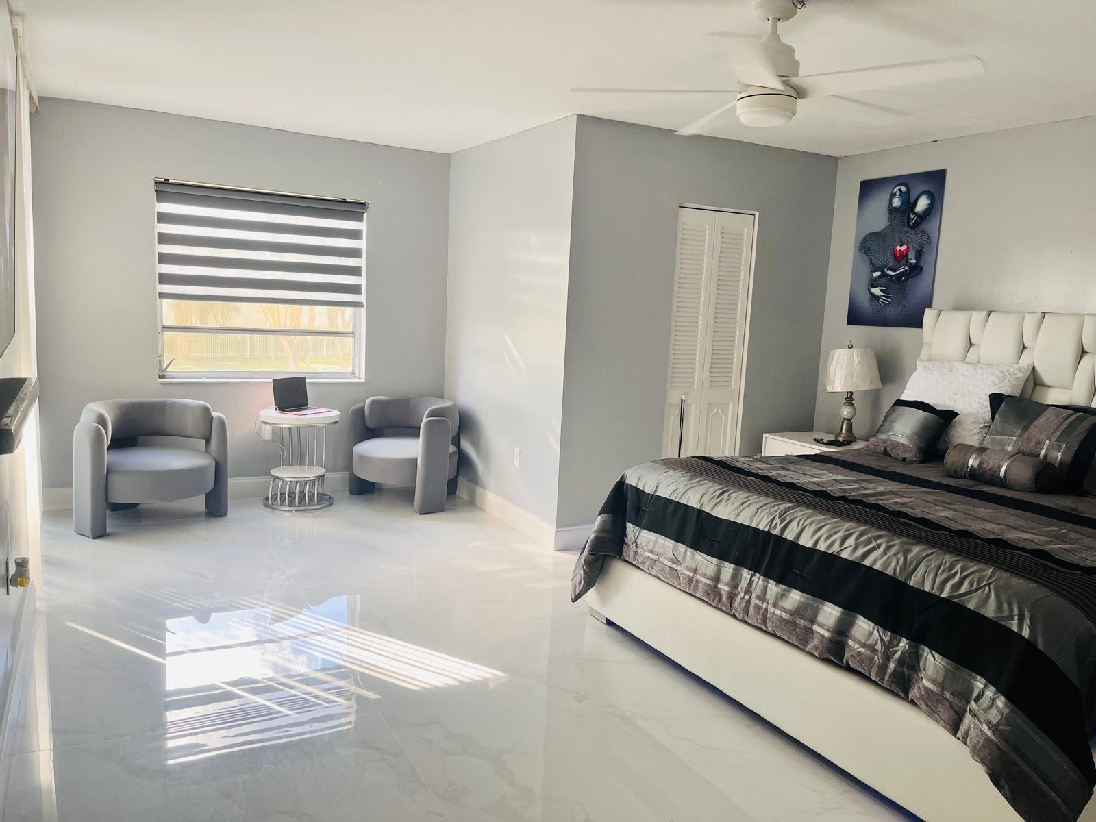 3910 Inverrary Boulevard, Unit 203B Lauderhill, FL 33319 - Photo 24 of 61 a bedroom with furniture and a large window