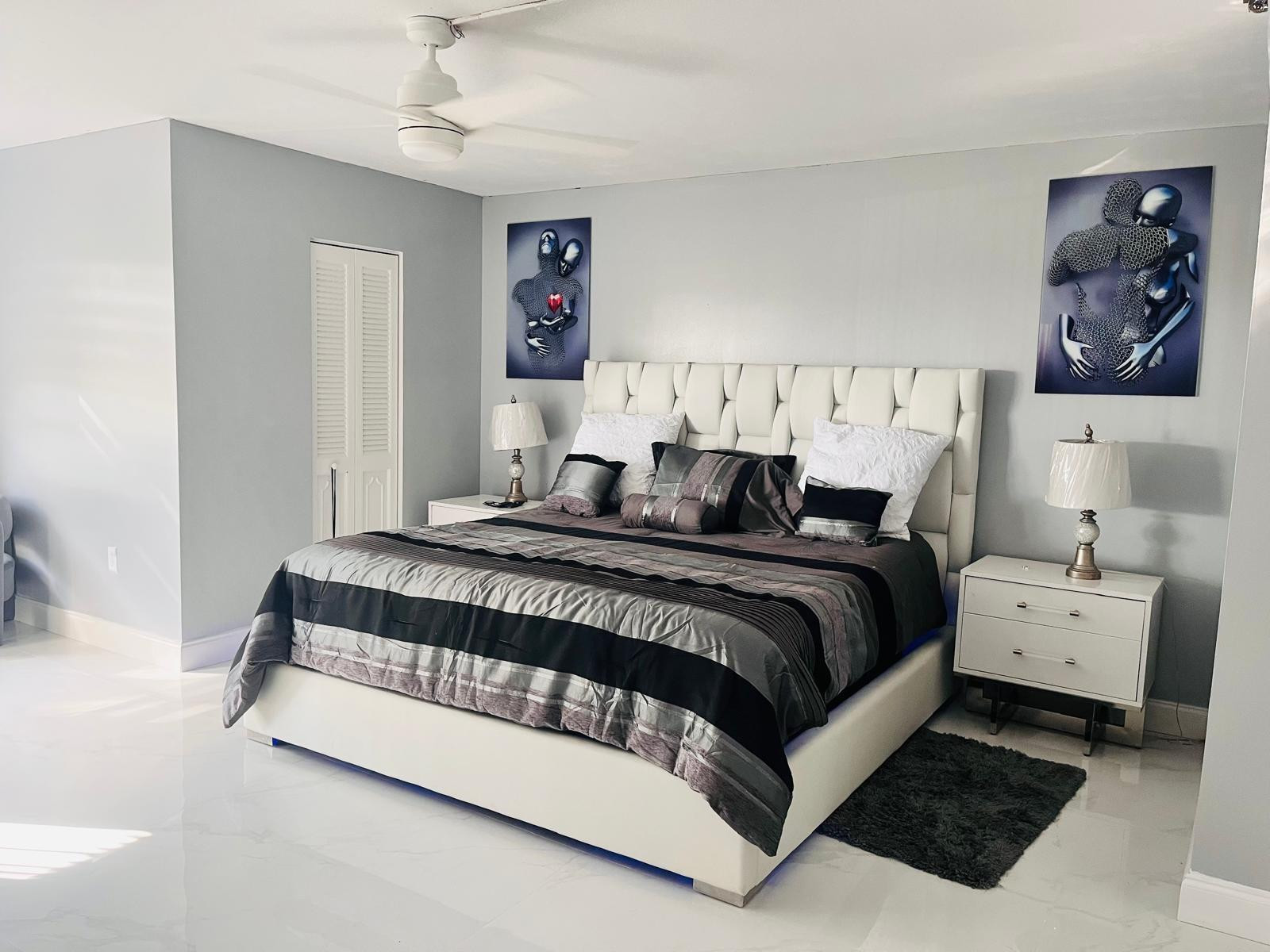 3910 Inverrary Boulevard, Unit 203B Lauderhill, FL 33319 - Photo 25 of 61 a bedroom with a bed and painting on the wall