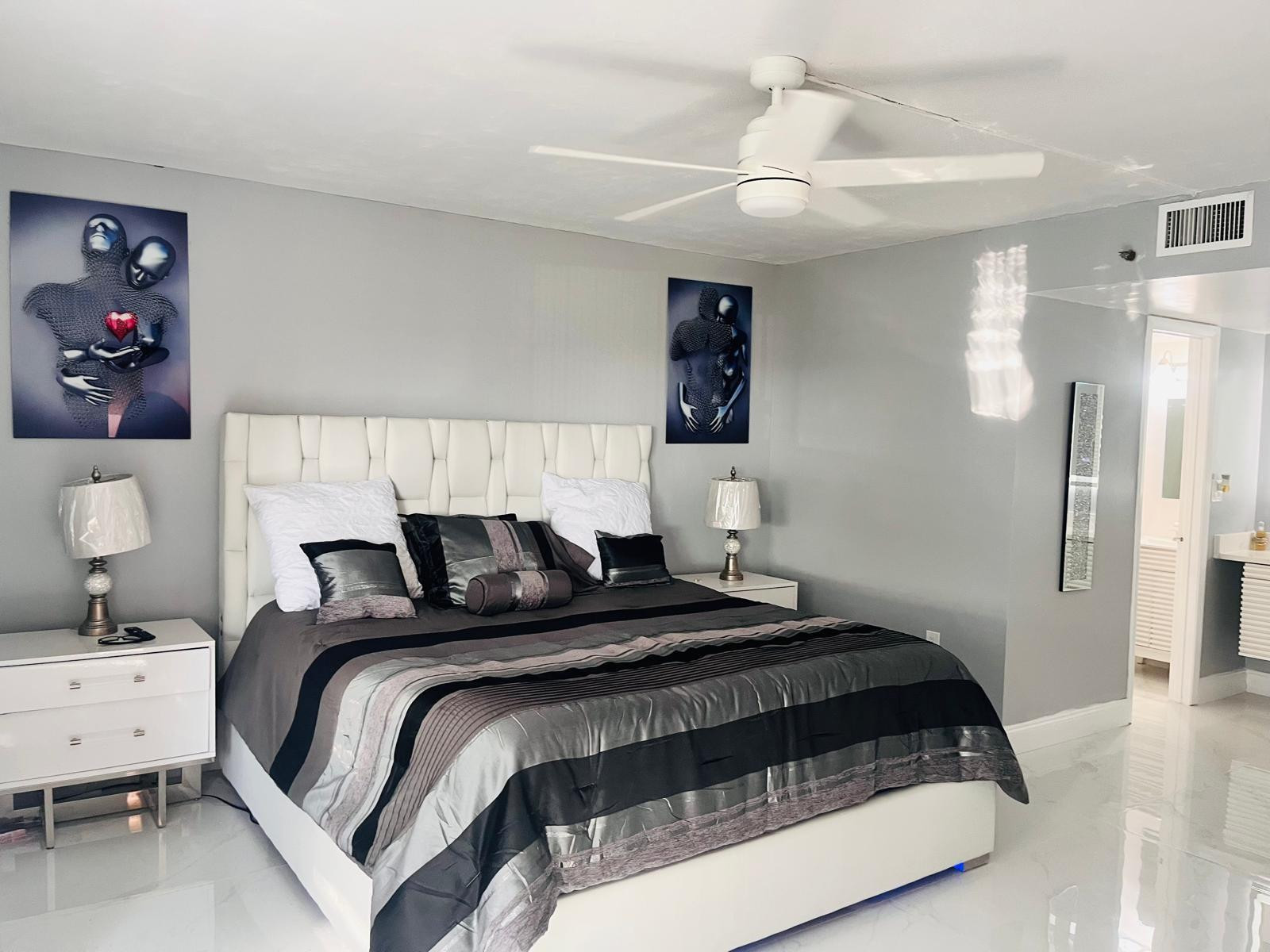 3910 Inverrary Boulevard, Unit 203B Lauderhill, FL 33319 - Photo 26 of 61 a bedroom with a bed and a chandelier