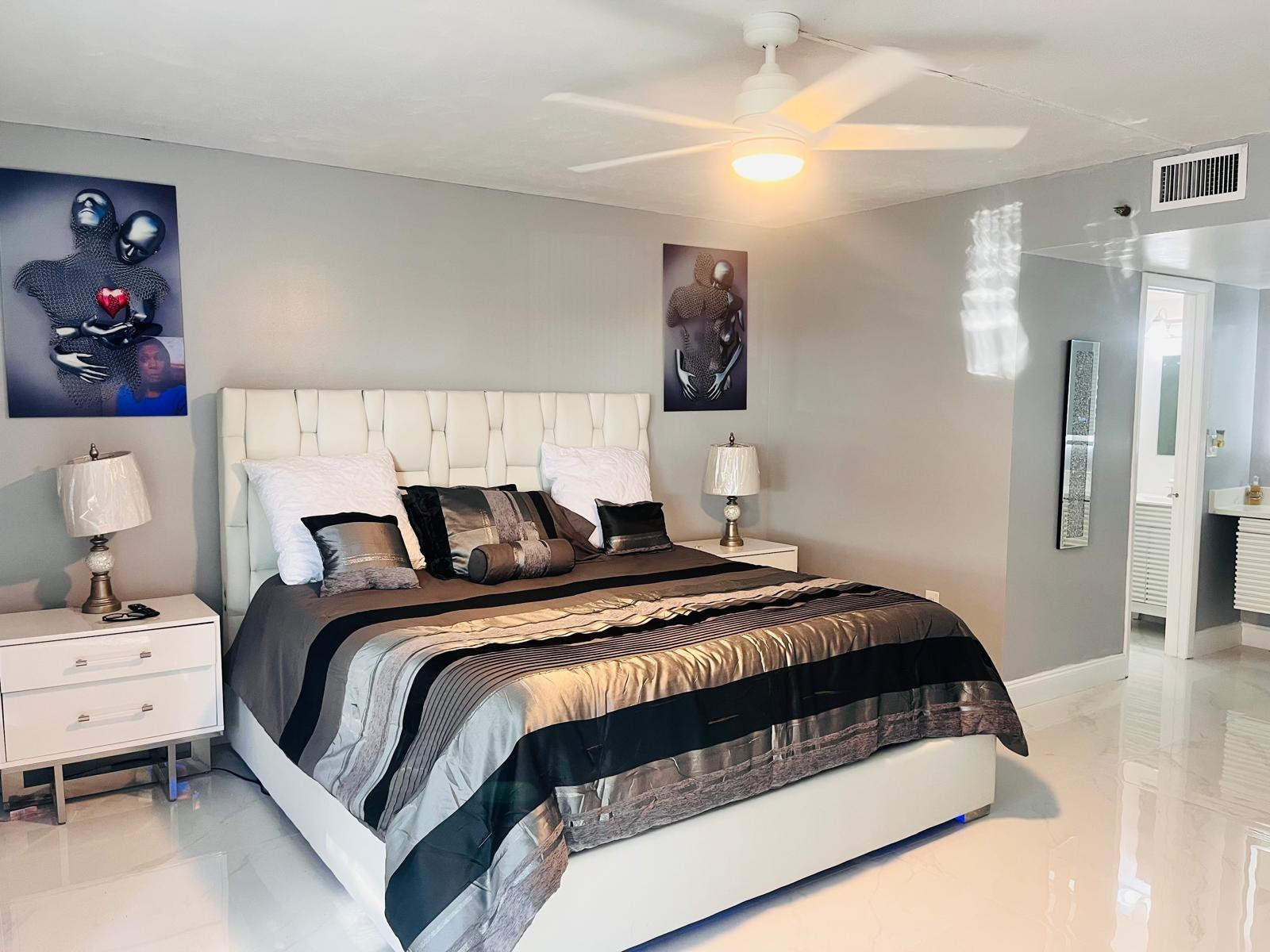3910 Inverrary Boulevard, Unit 203B Lauderhill, FL 33319 - Photo 27 of 61 a bedroom with a bed and a chandelier