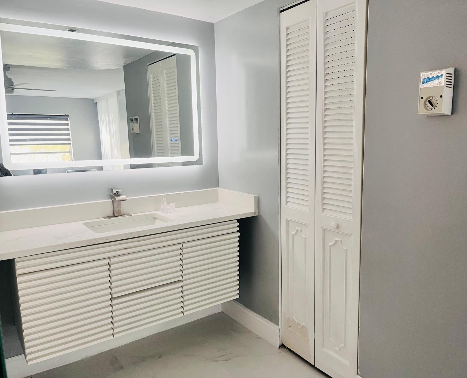 3910 Inverrary Boulevard, Unit 203B Lauderhill, FL 33319 - Photo 29 of 61 a bathroom with a sink and a mirror