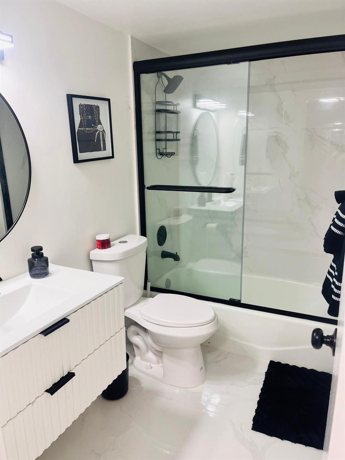 3910 Inverrary Boulevard, Unit 203B Lauderhill, FL 33319 - Photo 3 of 61 a bathroom with a sink toilet and a shower