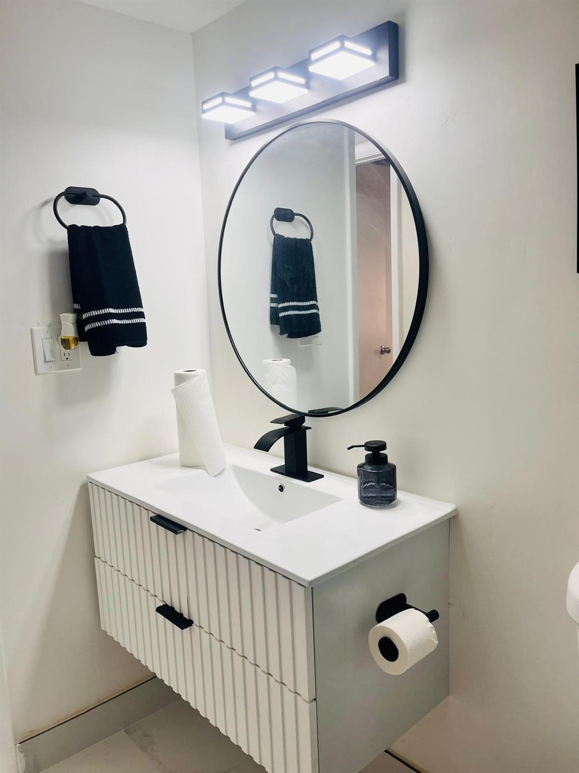 3910 Inverrary Boulevard, Unit 203B Lauderhill, FL 33319 - Photo 32 of 61 a bathroom with a sink and a mirror