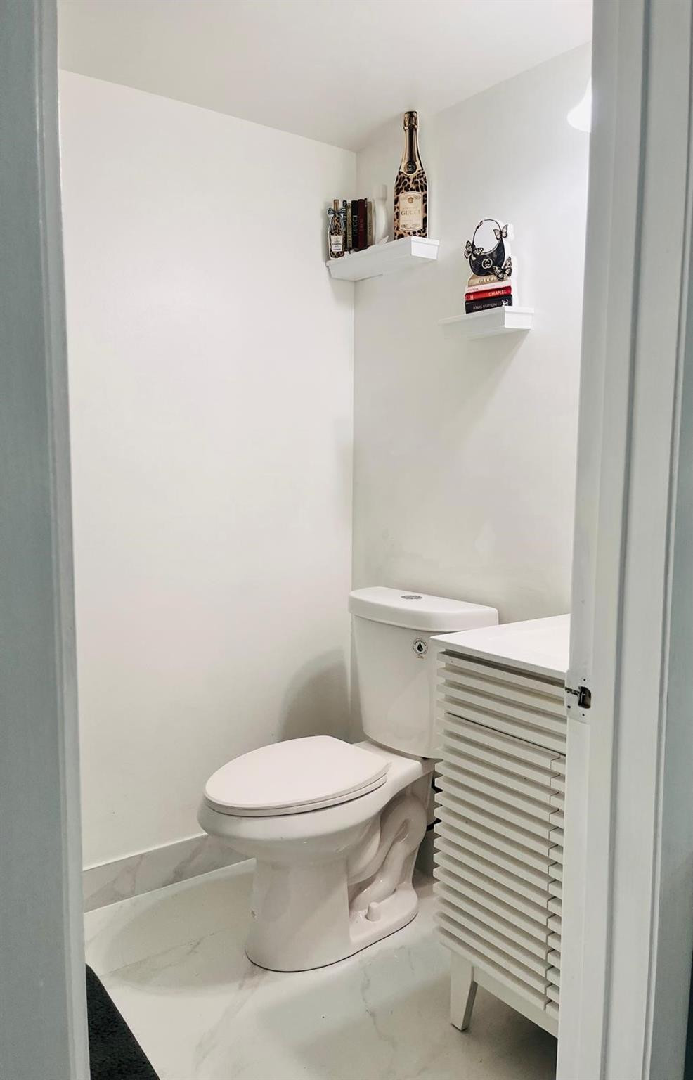 3910 Inverrary Boulevard, Unit 203B Lauderhill, FL 33319 - Photo 33 of 61 a white toilet sitting next to a bathroom sink