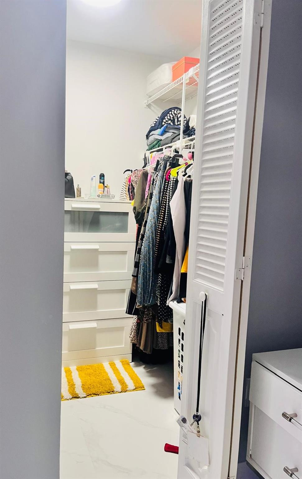 3910 Inverrary Boulevard, Unit 203B Lauderhill, FL 33319 - Photo 35 of 61 a view of walk in closet with clothes and shoes