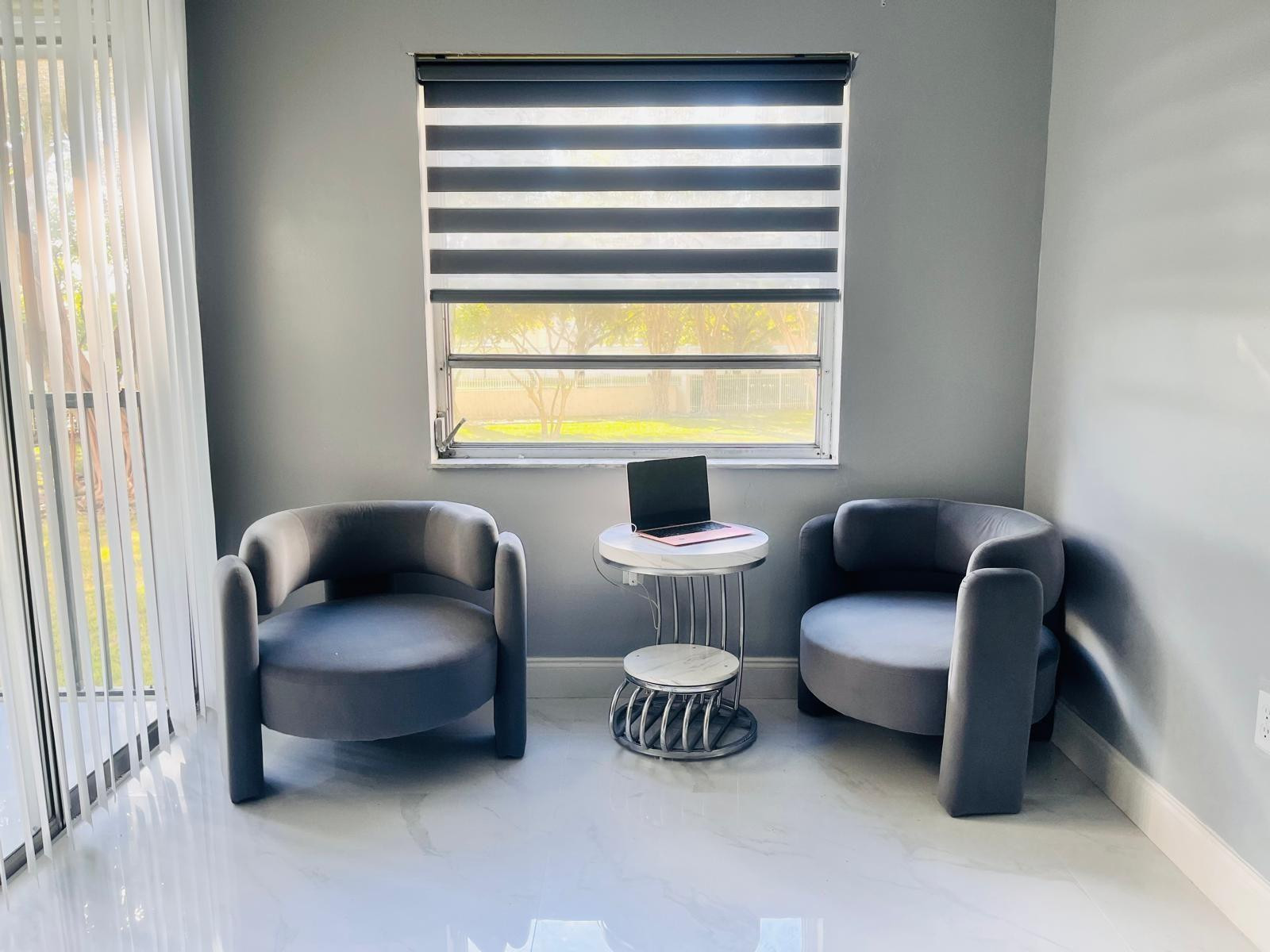 3910 Inverrary Boulevard, Unit 203B Lauderhill, FL 33319 - Photo 38 of 61 a living room with furniture and a window