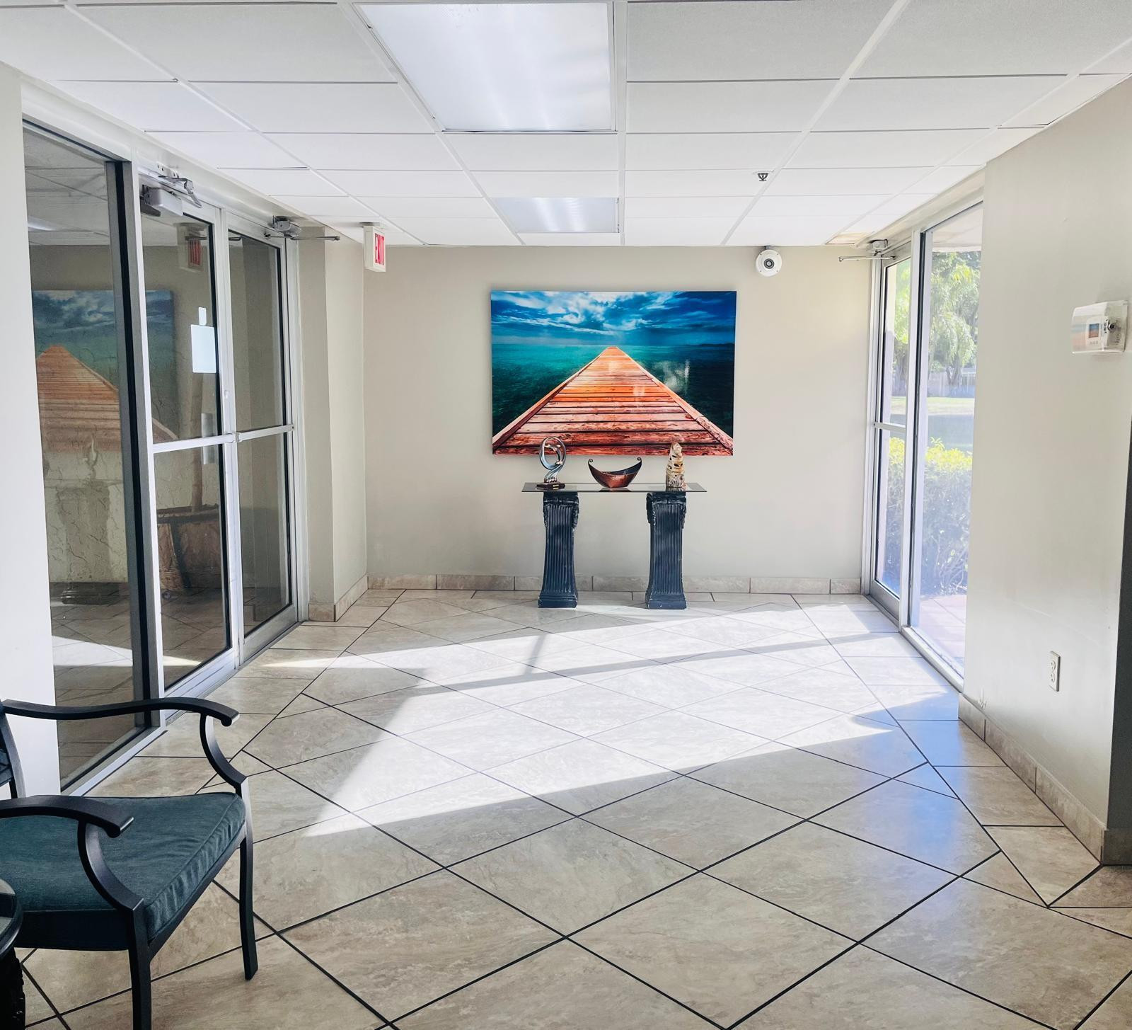 3910 Inverrary Boulevard, Unit 203B Lauderhill, FL 33319 - Photo 52 of 61 a bedroom with a bed and a table