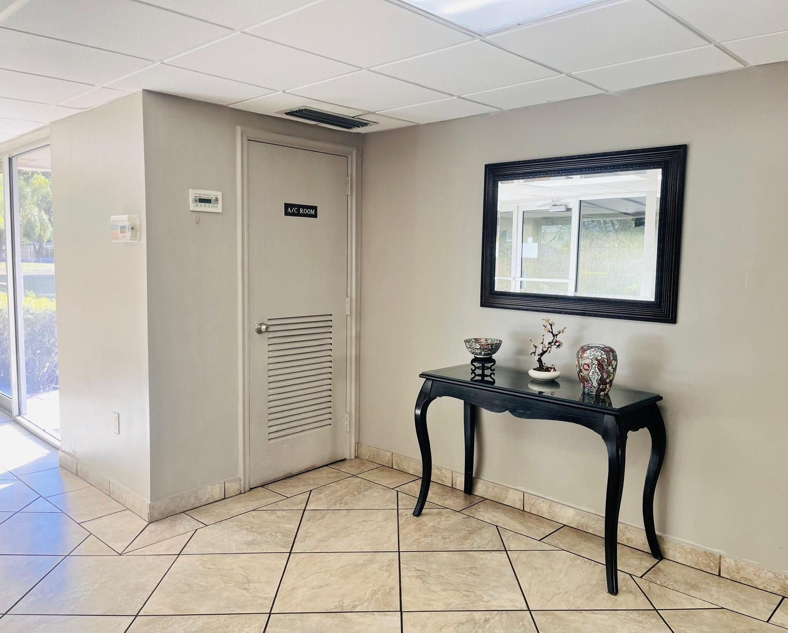 3910 Inverrary Boulevard, Unit 203B Lauderhill, FL 33319 - Photo 53 of 61 a bathroom with a sink and a mirror