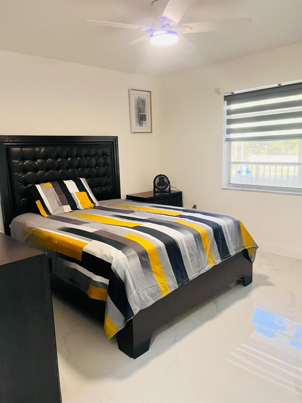 3910 Inverrary Boulevard, Unit 203B Lauderhill, FL 33319 - Photo 6 of 61 a bedroom with a bed and window