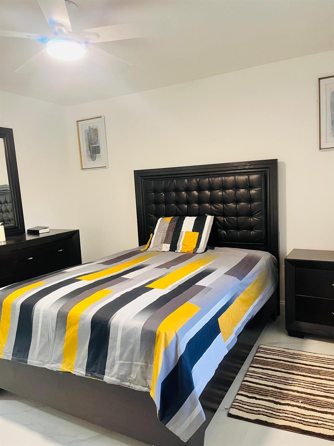 3910 Inverrary Boulevard, Unit 203B Lauderhill, FL 33319 - Photo 7 of 61 a bedroom with a bed and wooden floor