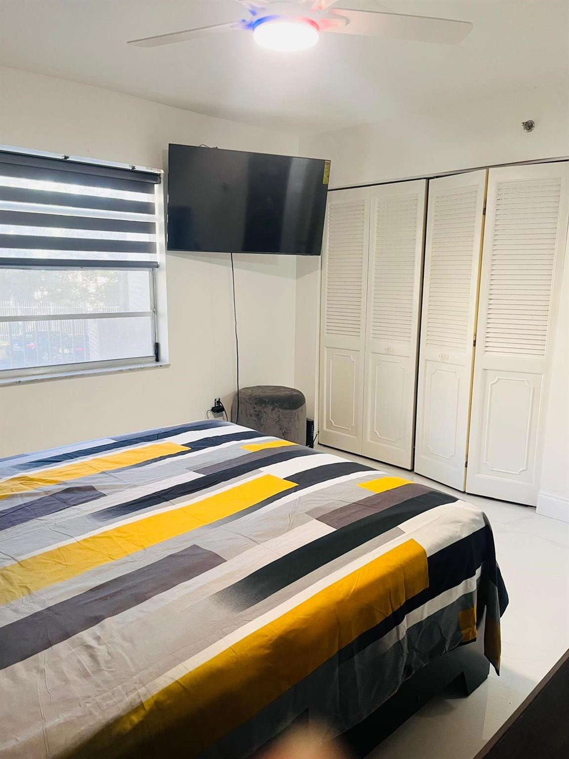 3910 Inverrary Boulevard, Unit 203B Lauderhill, FL 33319 - Photo 8 of 61 a bedroom with a bed and a flat screen tv