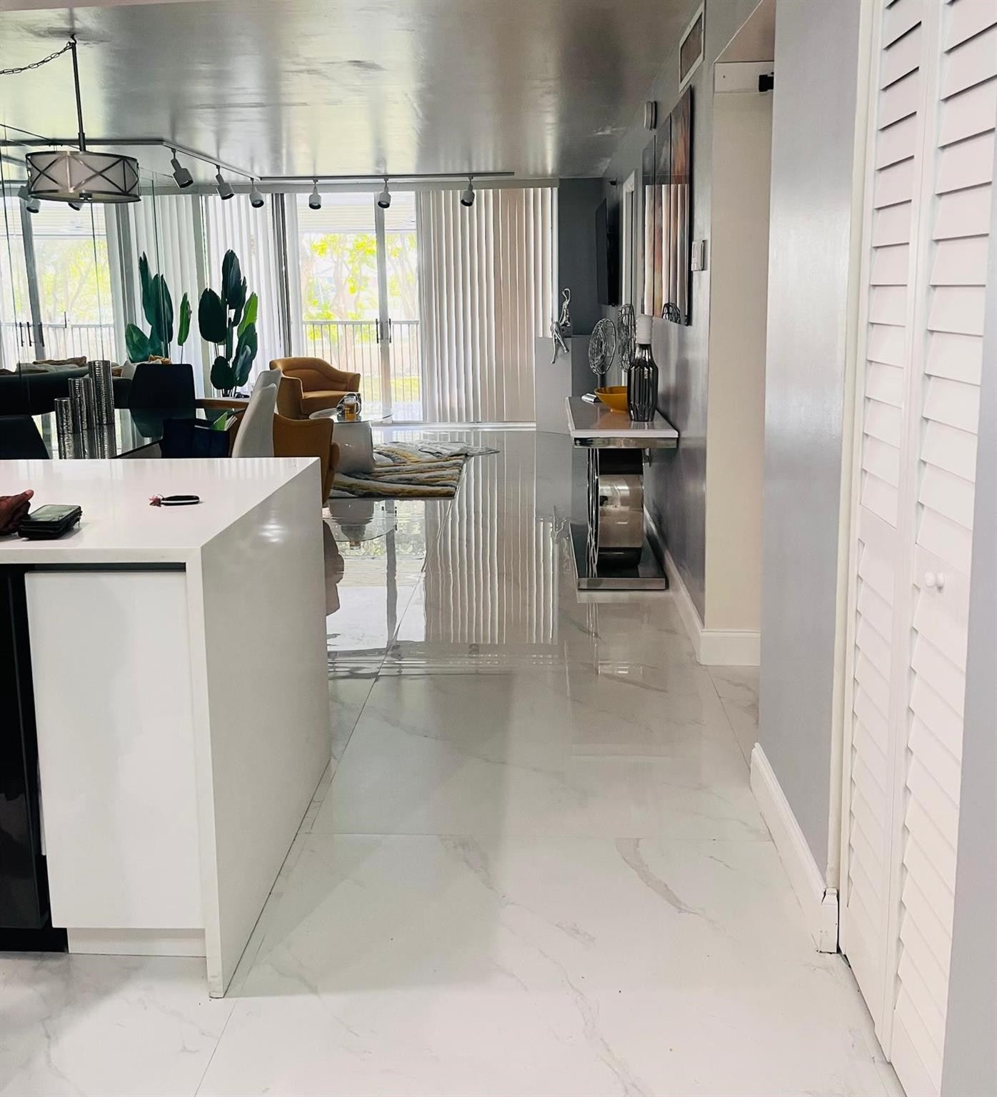 3910 Inverrary Boulevard, Unit 203B Lauderhill, FL 33319 - Photo 10 of 61 a dining room with furniture and a window