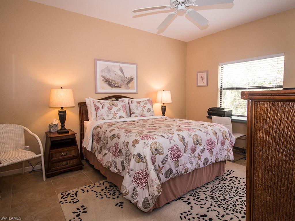 3321 Olympic Drive, Unit 623 Naples, FL 34105 - Photo 11 of 20 a bedroom with a bed and a lamp