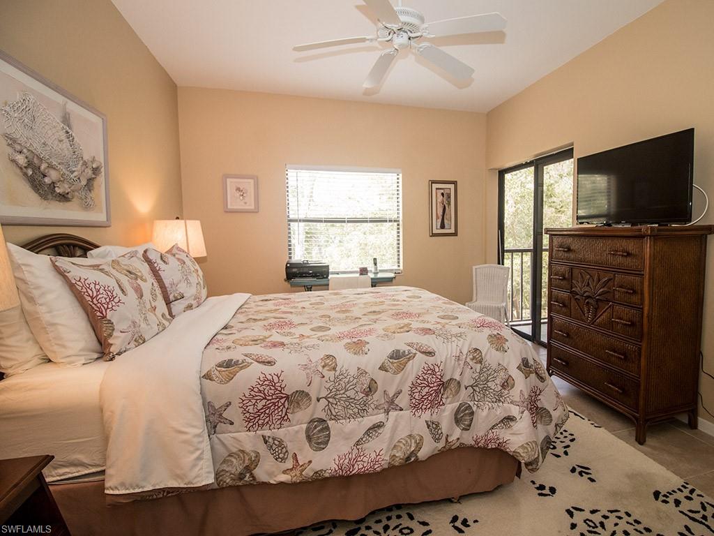 3321 Olympic Drive, Unit 623 Naples, FL 34105 - Photo 12 of 20 a spacious bedroom with a bed and a flat screen tv