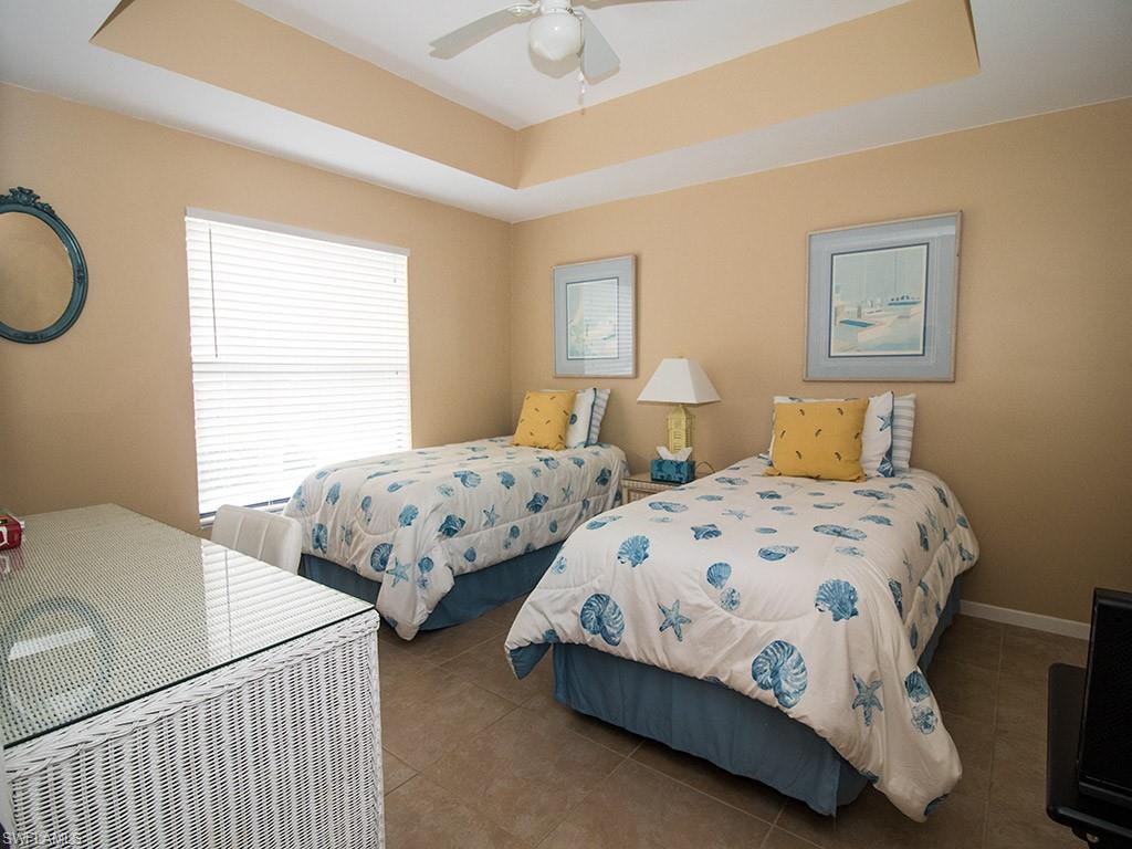 3321 Olympic Drive, Unit 623 Naples, FL 34105 - Photo 15 of 20 a bedroom with two beds and a window