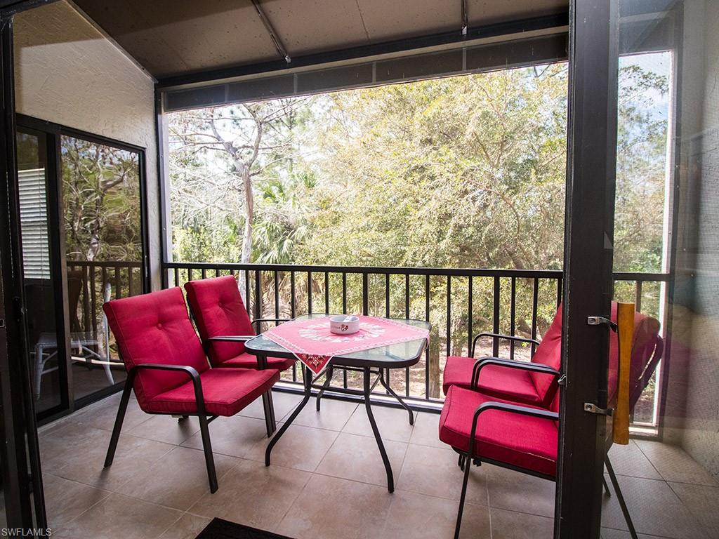 3321 Olympic Drive, Unit 623 Naples, FL 34105 - Photo 2 of 20 a view of a porch with furniture and a yard