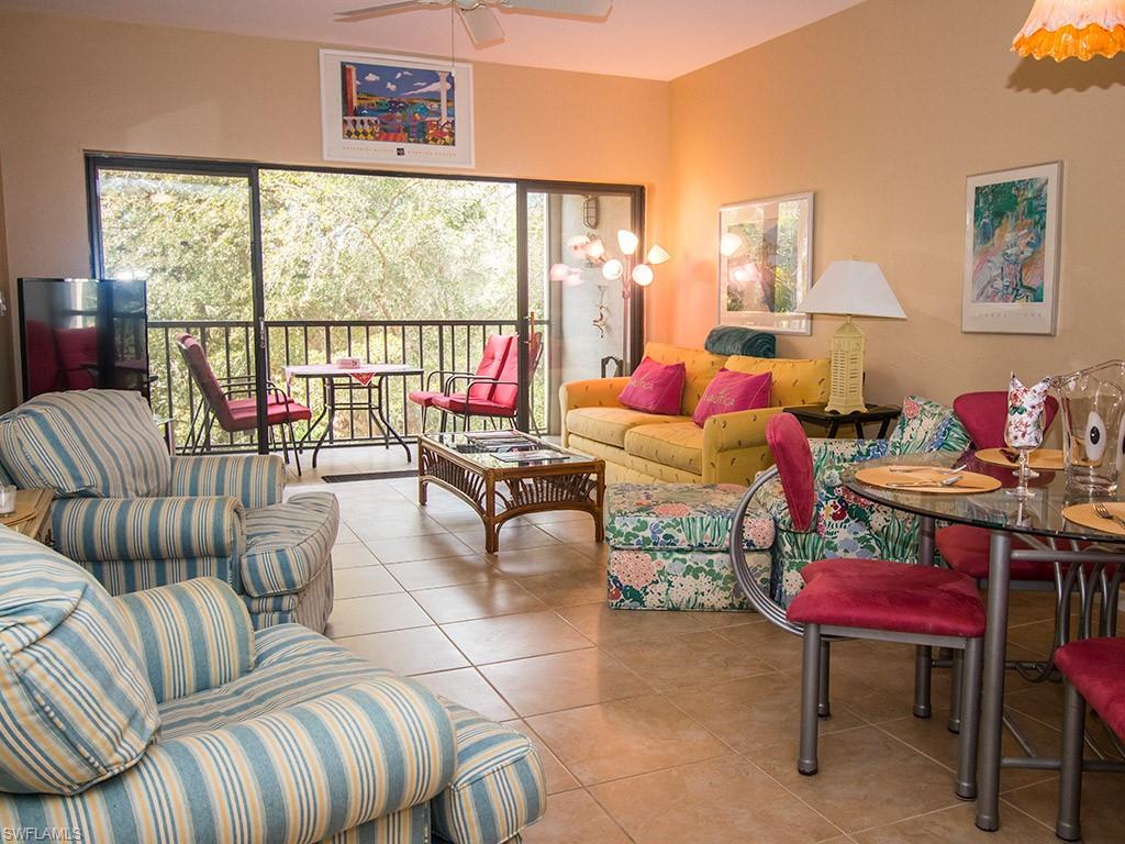 3321 Olympic Drive, Unit 623 Naples, FL 34105 - Photo 3 of 20 a living room with furniture and a large window