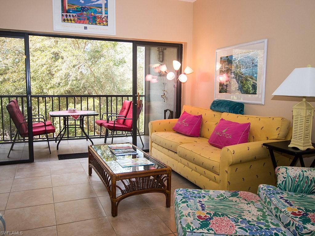 3321 Olympic Drive, Unit 623 Naples, FL 34105 - Photo 4 of 20 a living room with furniture and a large window