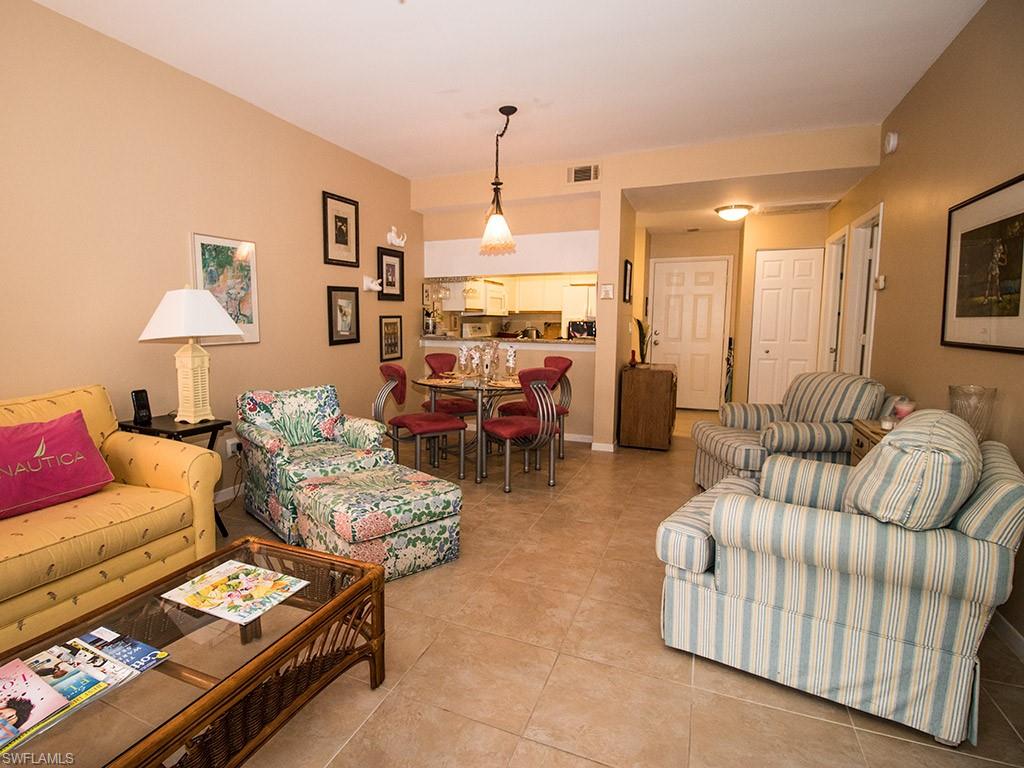 3321 Olympic Drive, Unit 623 Naples, FL 34105 - Photo 5 of 20 a living room with furniture and a chandelier