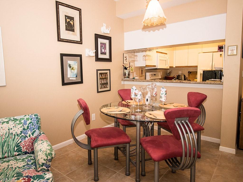3321 Olympic Drive, Unit 623 Naples, FL 34105 - Photo 7 of 20 a view of a dining room with furniture window and outside view