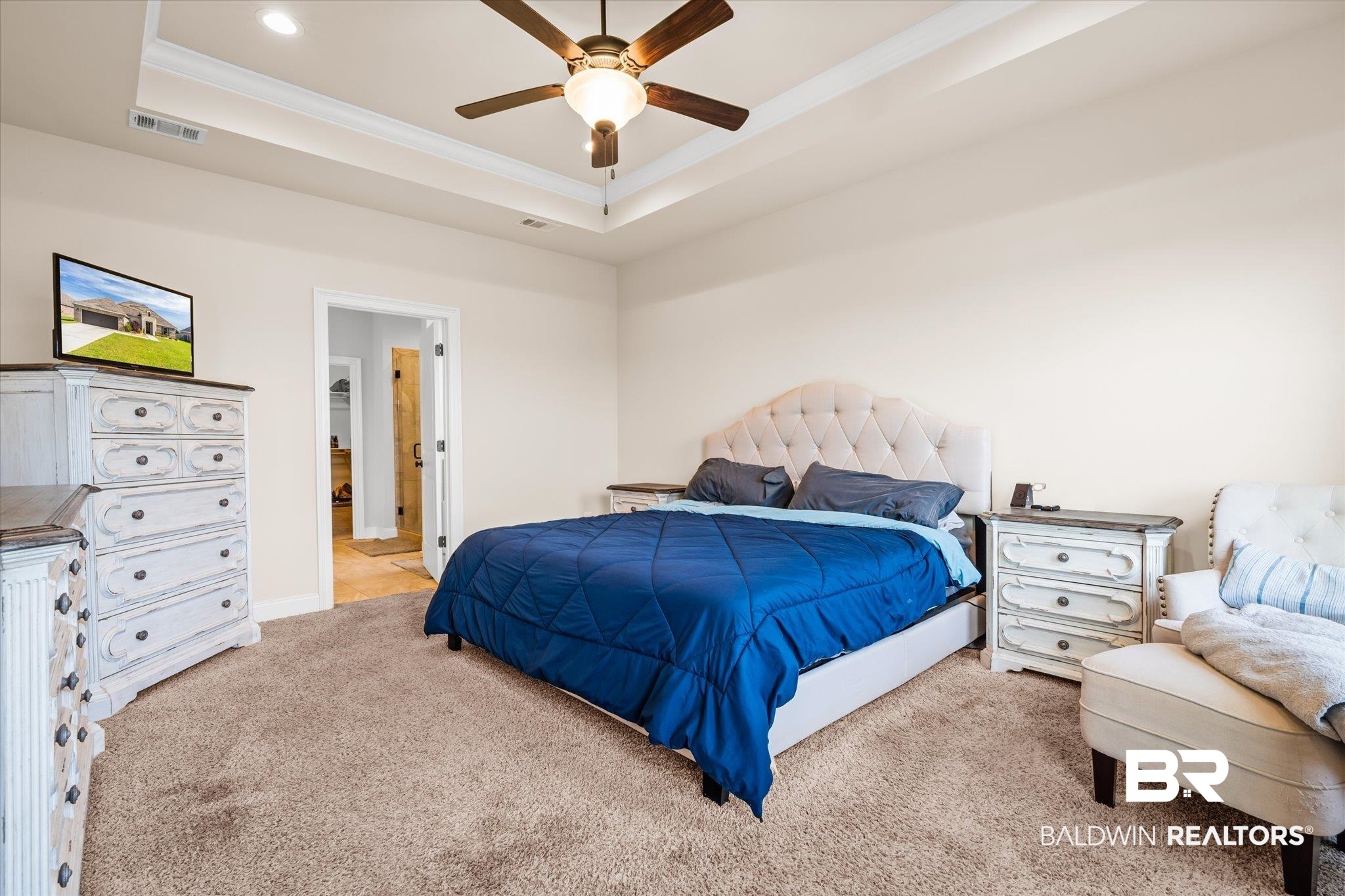 9912 Dunleith Loop Daphne, AL 36526 - Photo 8 of 23 Carpeted bedroom with crown molding, a ceiling fan, and a tray ceiling