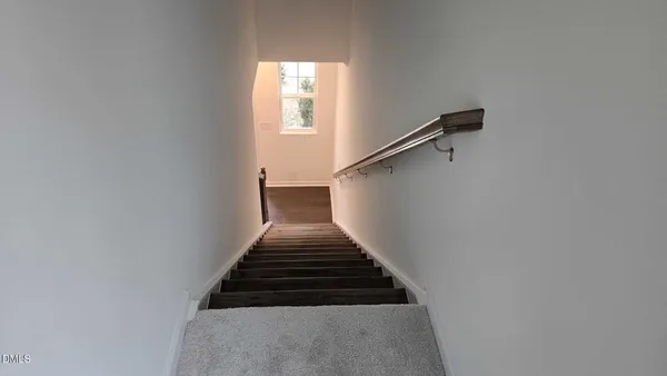 a picture of a bench in front of a wall