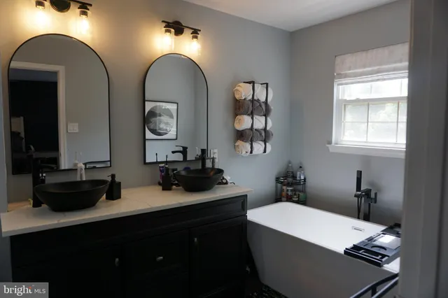 a bathroom with a double vanity sink and a mirror