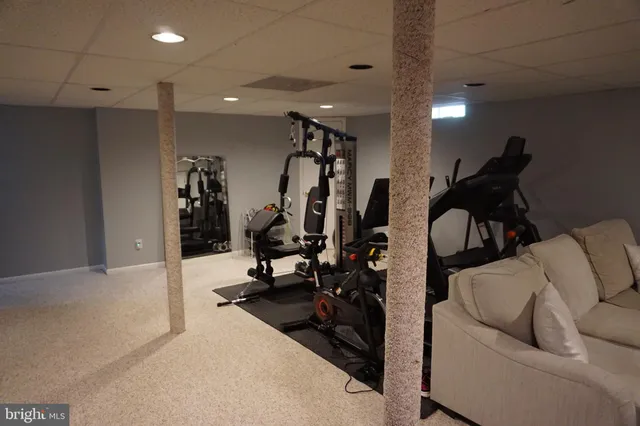 a view of a roof deck with wooden fence and a couple of chairs