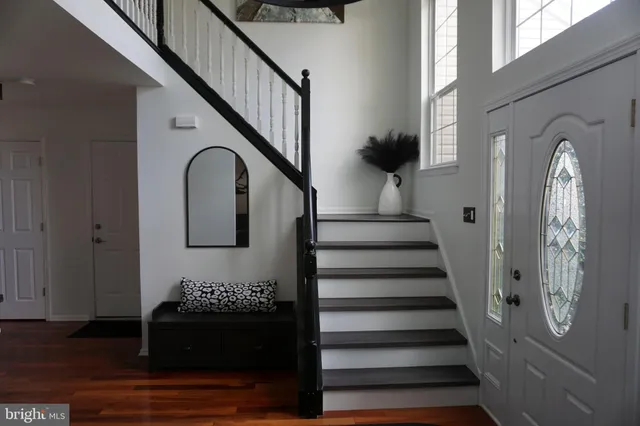 a view of entryway and hall with wooden floor