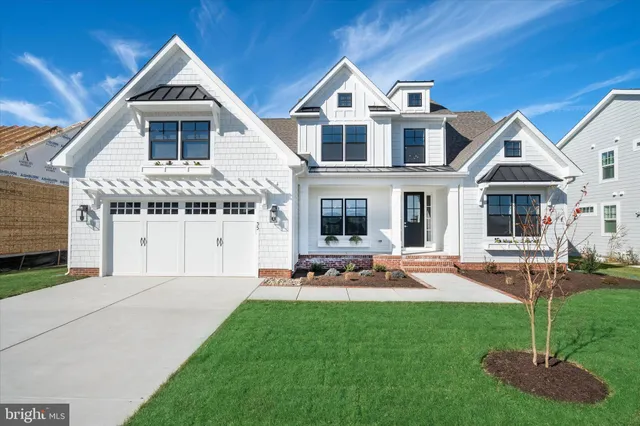 a front view of a house with sitting area and garden