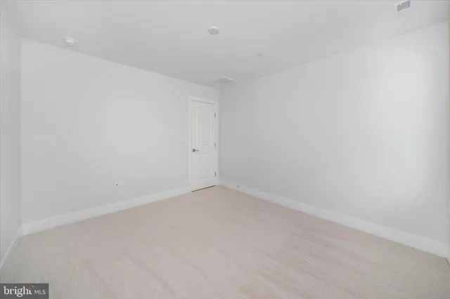 a white house with tree in front of it