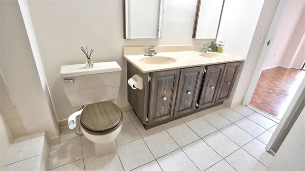 a bathroom with a sink toilet and mirror