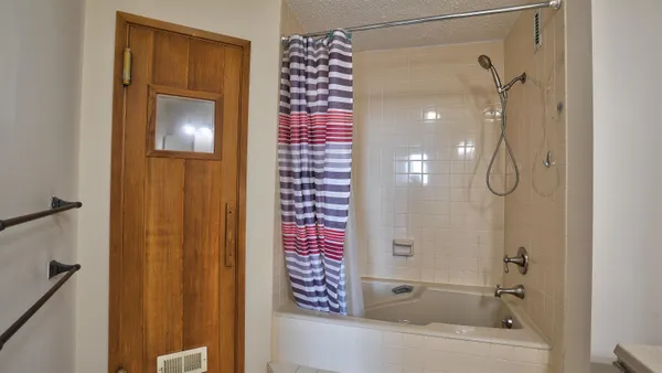 a bathroom with a shower and a sink