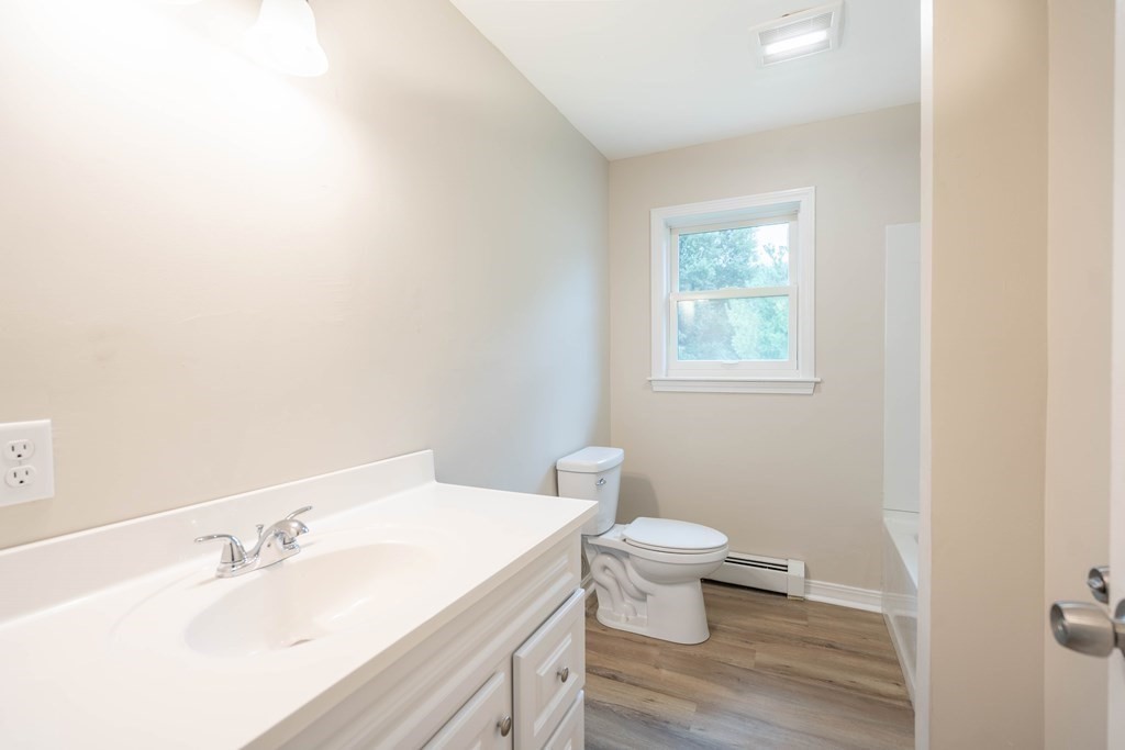 6 Meadowbrook Lane Spencer, MA 01562 - Photo 19 of 39 a bathroom with a sink a toilet and a window