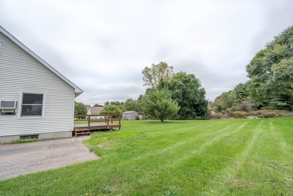 6 Meadowbrook Lane Spencer, MA 01562 - Photo 30 of 39 a view of a backyard with plants and a garden