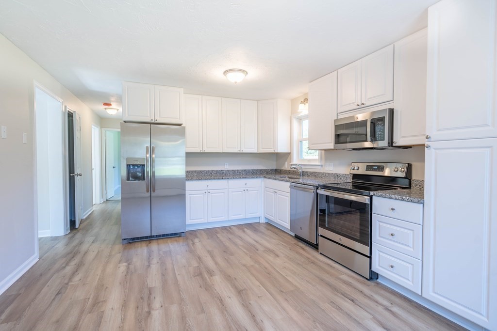6 Meadowbrook Lane Spencer, MA 01562 - Photo 10 of 39 a kitchen with granite countertop a refrigerator stove top oven and sink
