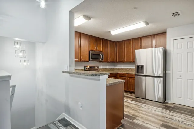 a kitchen with a refrigerator sink and microwave