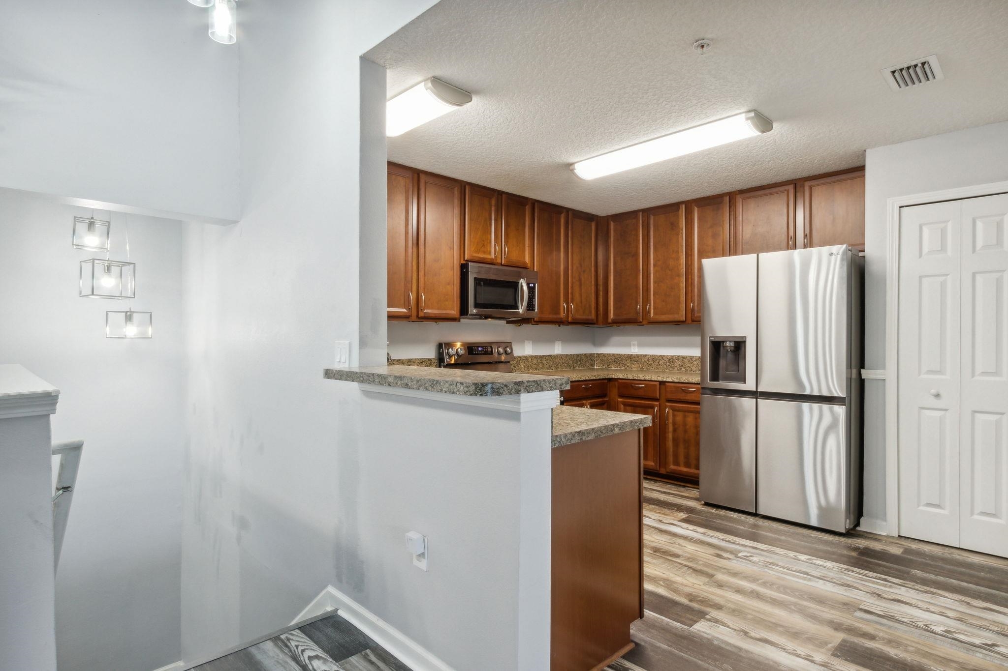 404 Golden Lake Loop St. Augustine, FL 32084 - Photo 12 of 38 a kitchen with a refrigerator sink and microwave