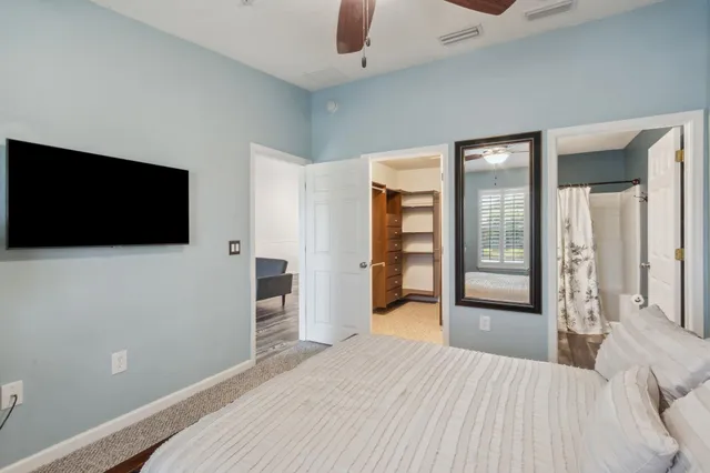a bedroom with a bed and a flat screen tv