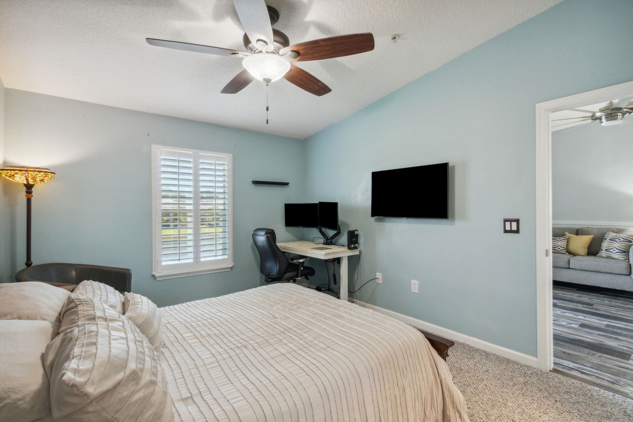 404 Golden Lake Loop St. Augustine, FL 32084 - Photo 16 of 38 a bedroom with a bed and a flat screen tv