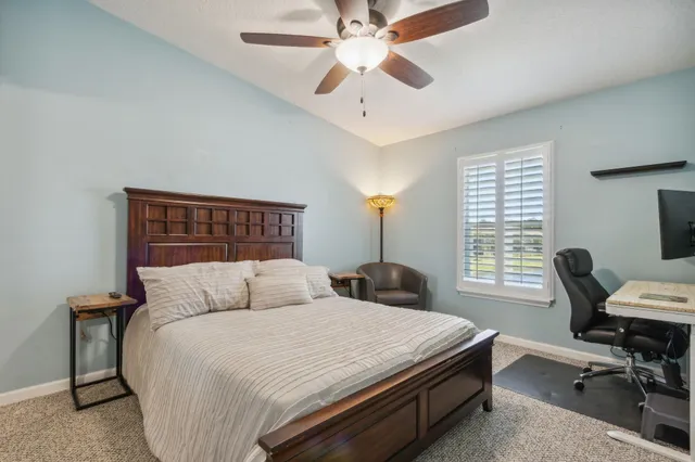 a bedroom with a bed and a desk