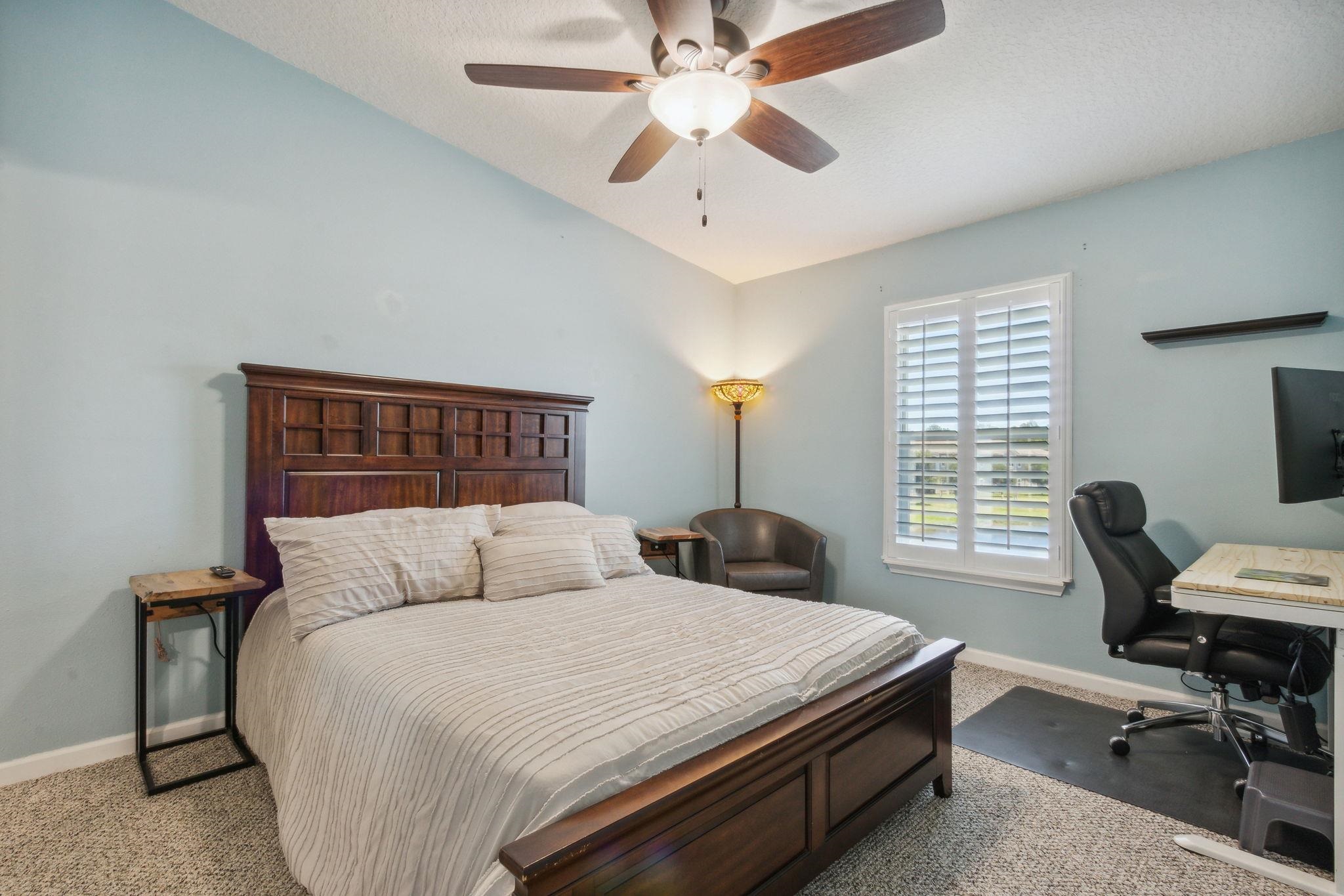 404 Golden Lake Loop St. Augustine, FL 32084 - Photo 17 of 38 a bedroom with a bed and a desk