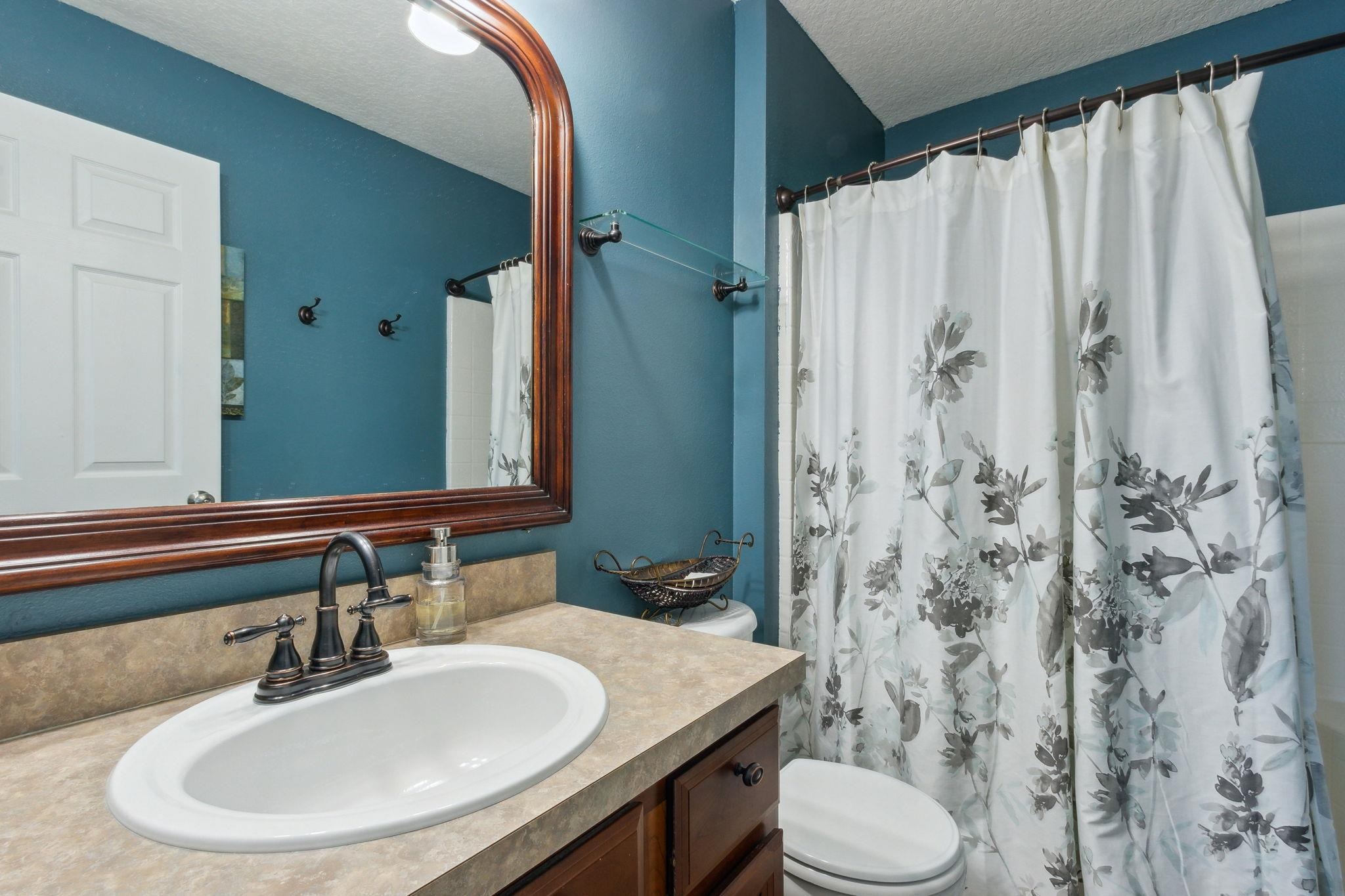 404 Golden Lake Loop St. Augustine, FL 32084 - Photo 19 of 38 a bathroom with a sink toilet and shower