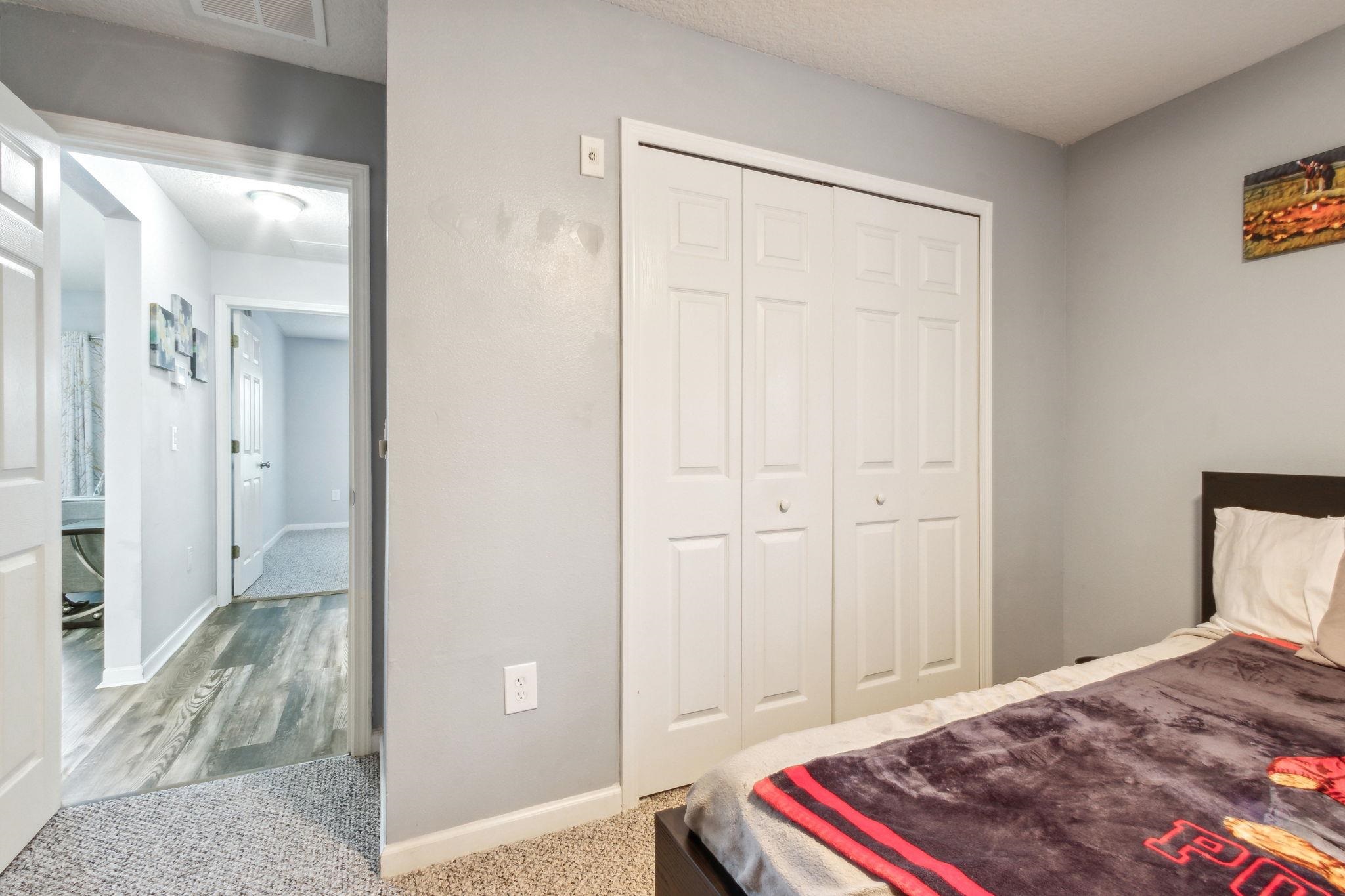404 Golden Lake Loop St. Augustine, FL 32084 - Photo 20 of 38 a bedroom with a bed and a chandelier
