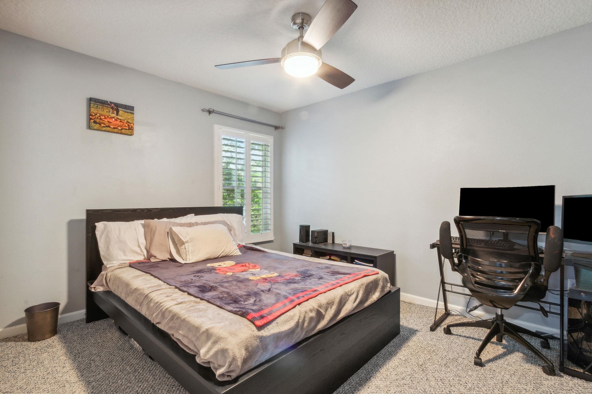 404 Golden Lake Loop St. Augustine, FL 32084 - Photo 21 of 38 a bedroom with a bed and a chandelier